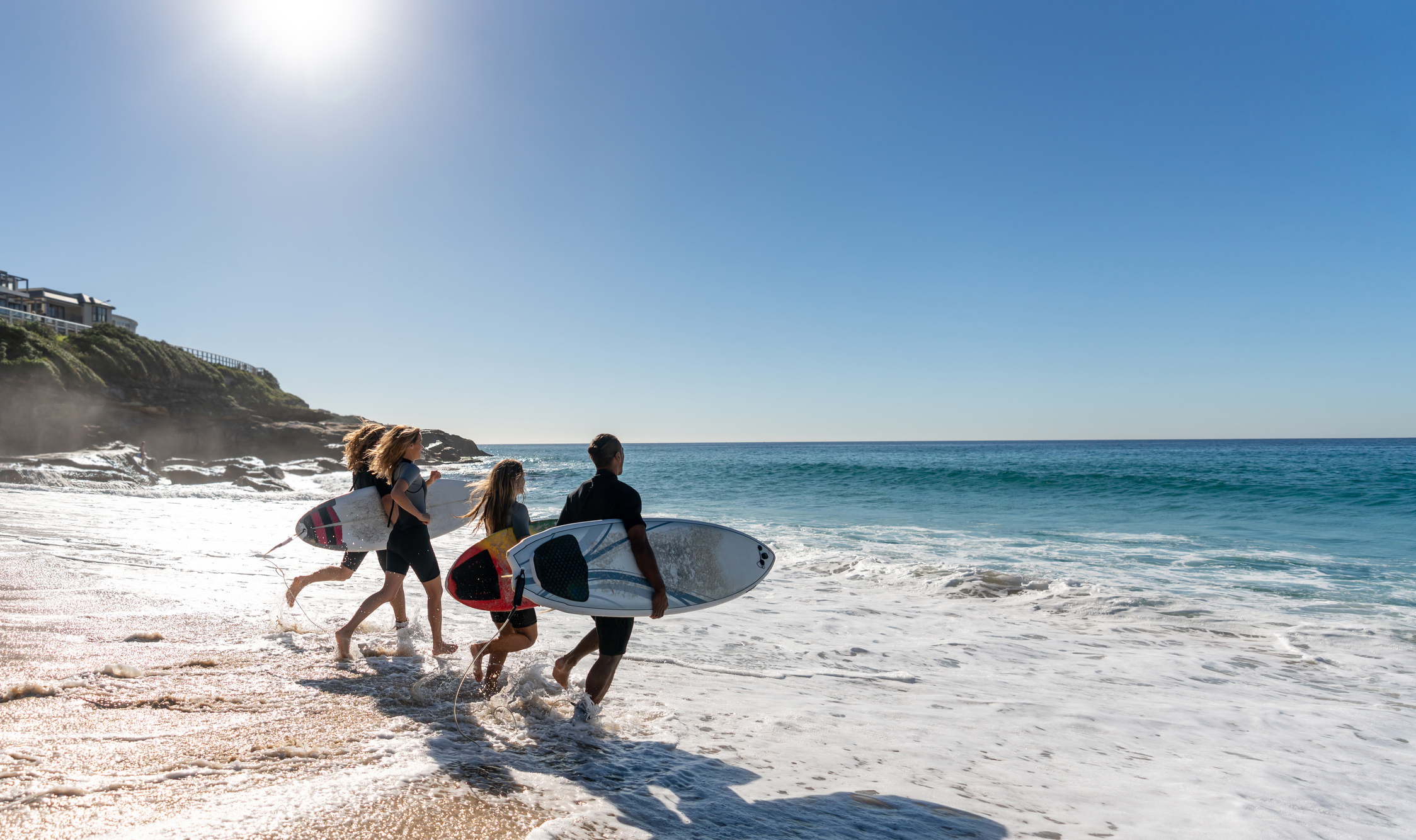Group running to surf